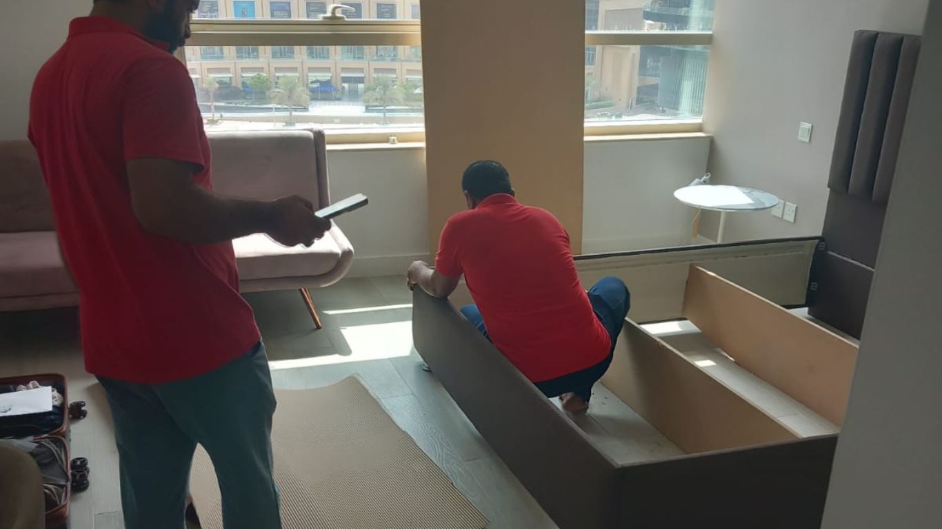 Dubai movers carefully loading furniture onto truck