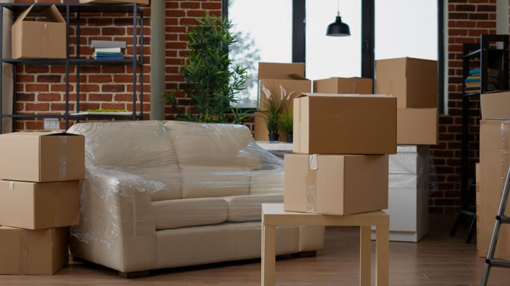 Moving boxes stacked neatly in an Abu Dhabi apartment with a landmark in the background