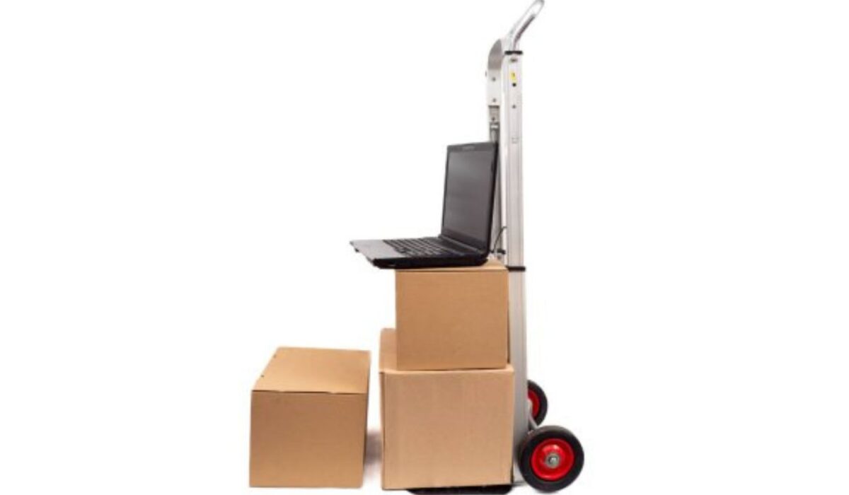 Moving boxes stacked neatly in an Abu Dhabi apartment with a landmark in the background