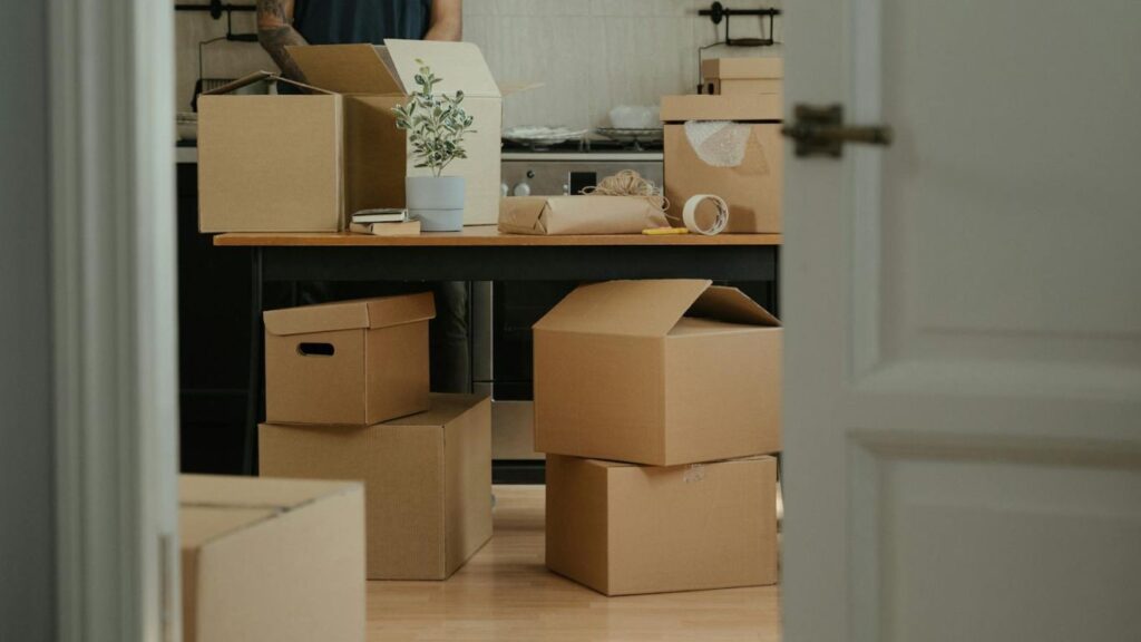 Moving boxes stacked neatly in an Abu Dhabi apartment with a landmark in the background