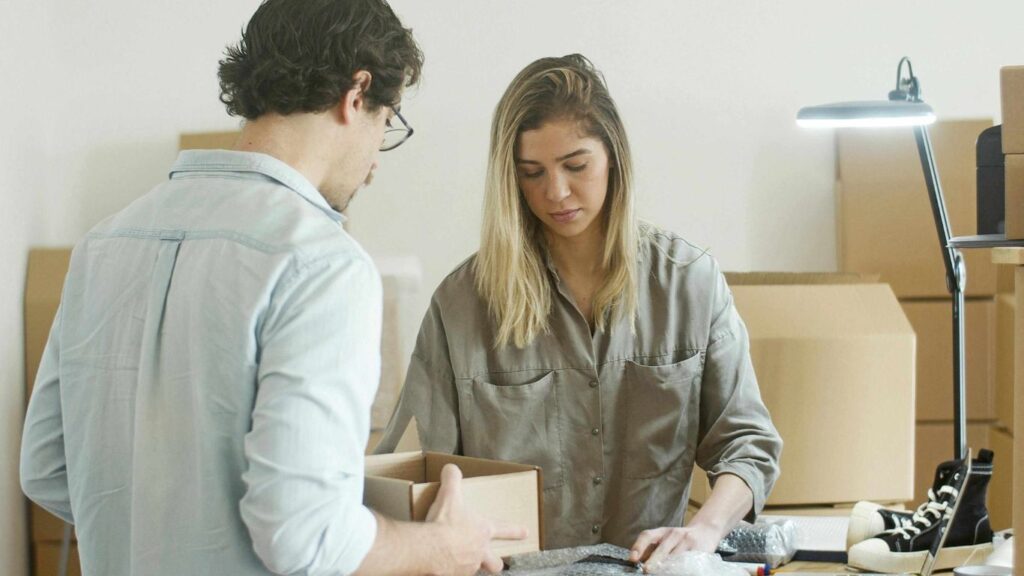 Office movers carefully loading furniture onto a truck in Dubai