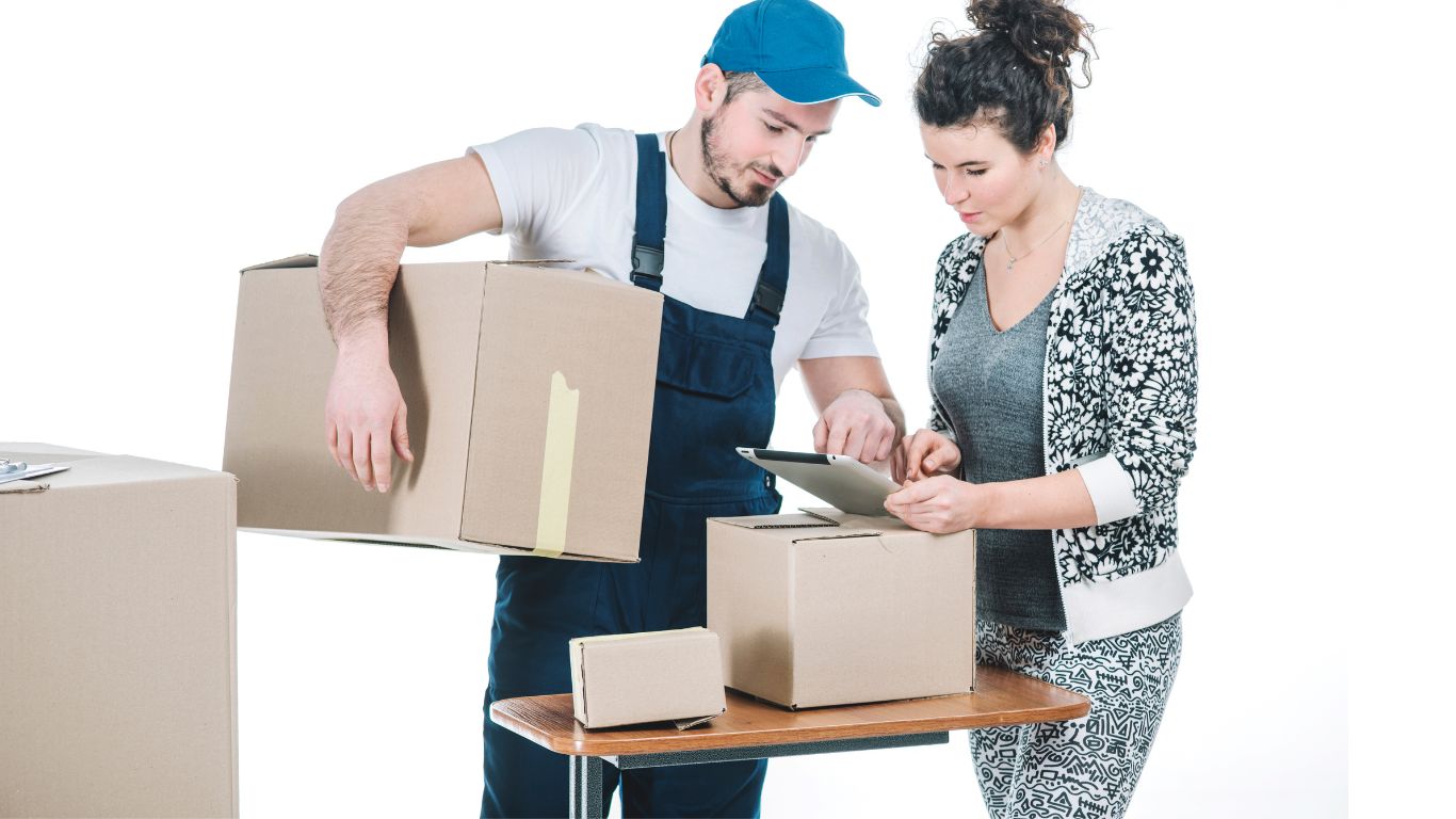 Two movers carrying boxes into a house in Al Ain, UAE.