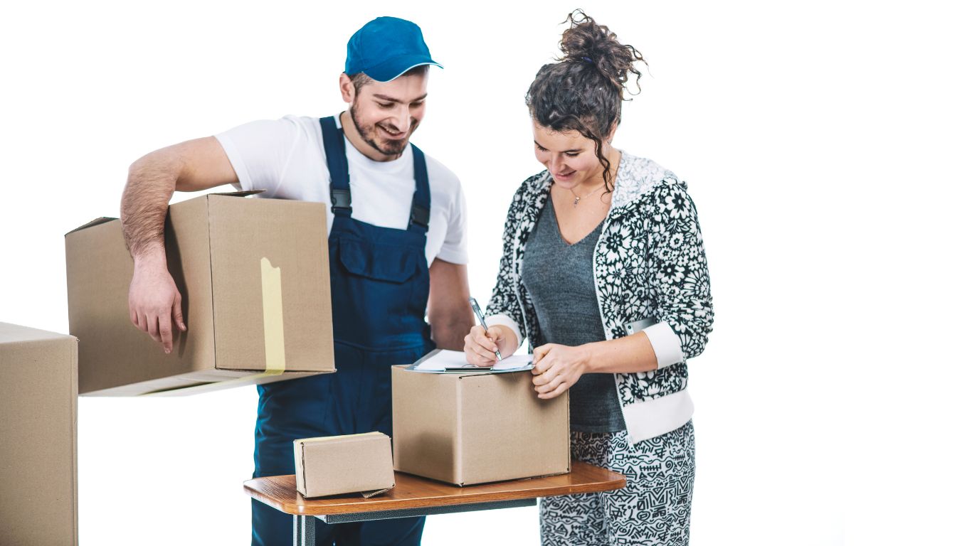 Two movers loading boxes onto a moving truck in Abu Dhabi, UAE.